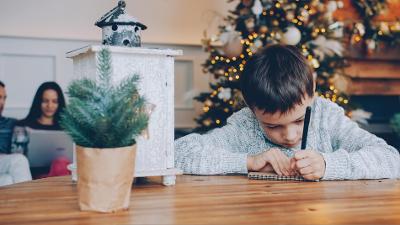 Young boy writing a letter to santa