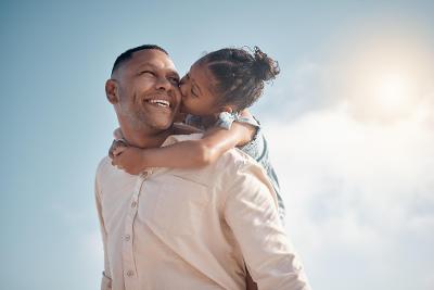 Man with young girl on shoulder kissing cheek - training