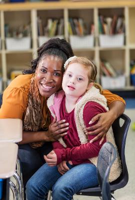 Woman with young girl on a chair team support